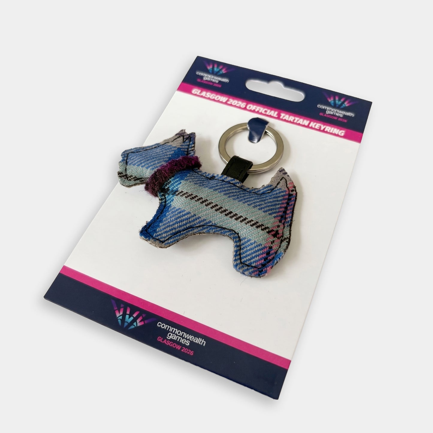 Glasgow 2026 Country Green Tartan Dog Keyring attached to branded backing card on grey background