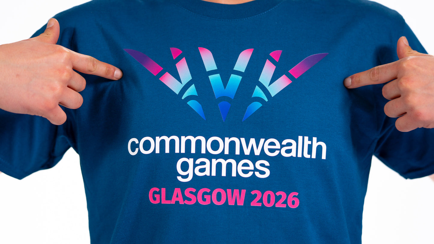 Close up of man wearing denim blue t-shirt showing full colour Glasgow 2026 Logo.