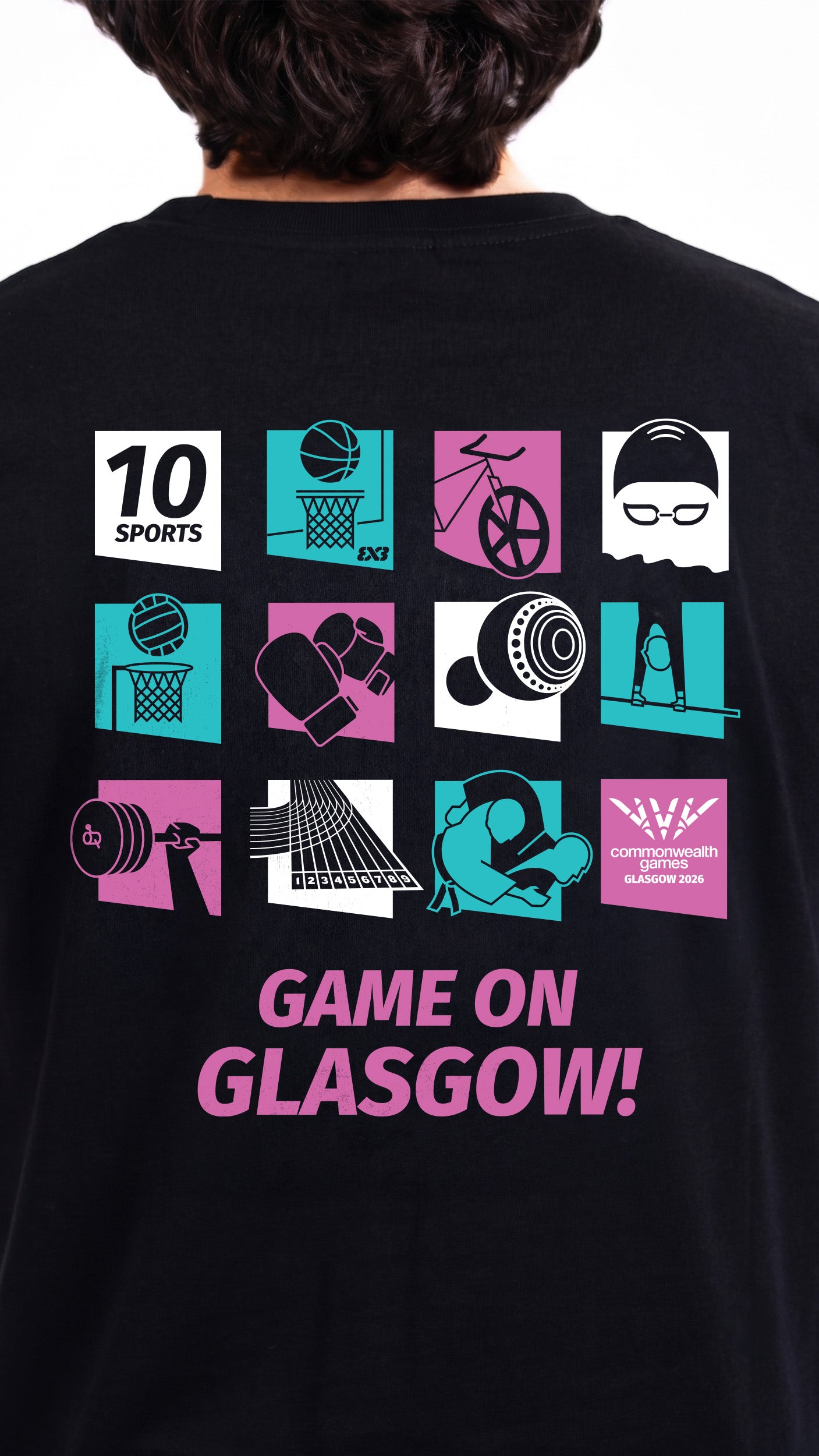 Close up view of man wearing black pictogram t-shirt showing Glasgow 2026 pictograms for each sport on the back.