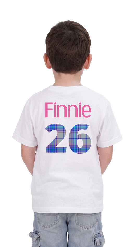 Back view of young boy wearing white Finnie 26 Competition Winning T-Shirt showing back view with Finnie's name and 26 in the Games official tartan.