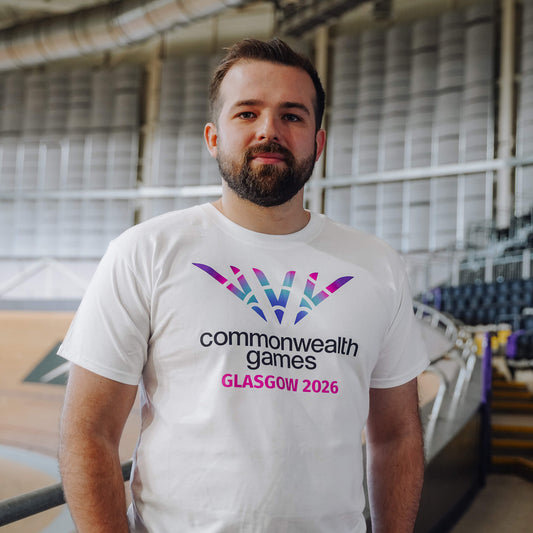 Man wearing white Glasgow 2026 logo t-shirt