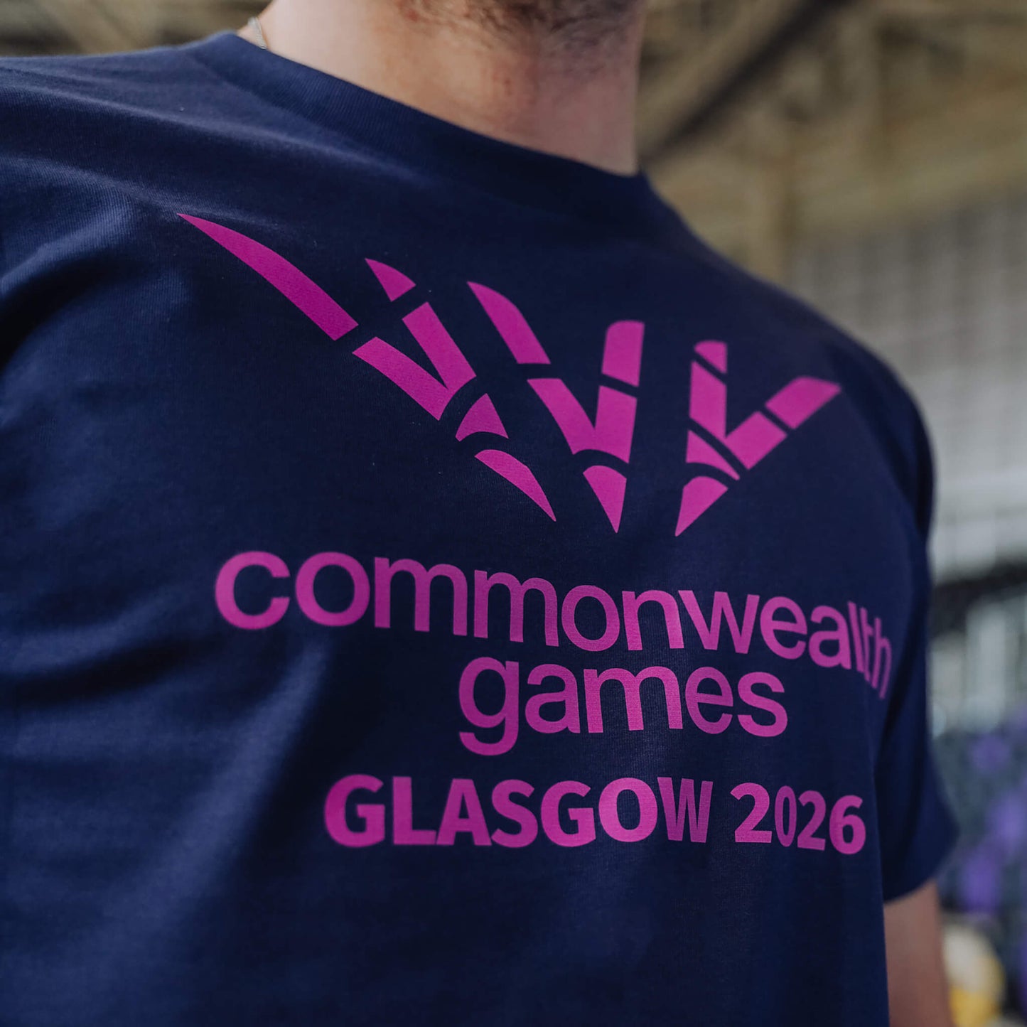 Close up of navy single colour Glasgow 2036 logo t-shirt showing chest print