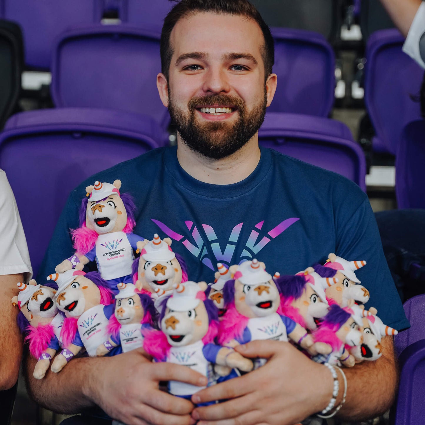 Man holding a bunch of Glasgow 2026 Finnie Mascots - 25cm