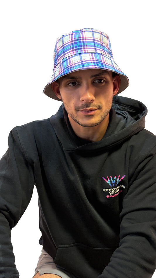 Man wearing Glasgow 2026 logo bucket tat showing tartan reverse side.