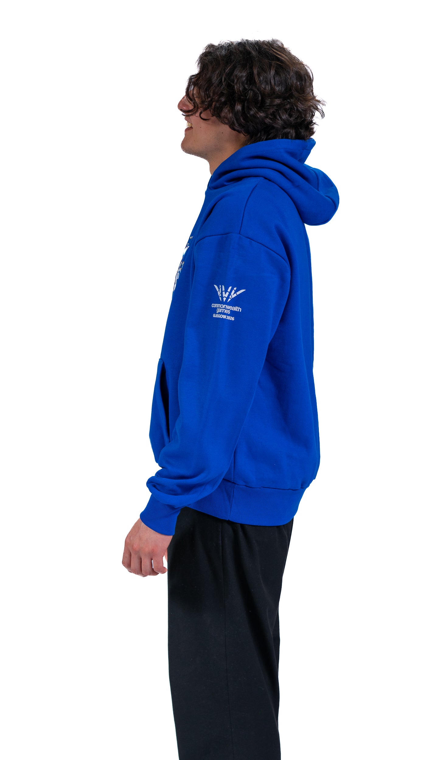 Side view of man wearing blue Glasgow 2026 Celebration graphic hoodie.