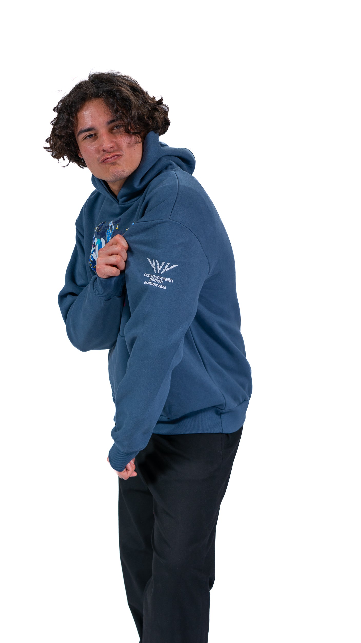 Side view of man wearing denim Glasgow 2026 Celebration graphic hoodie.