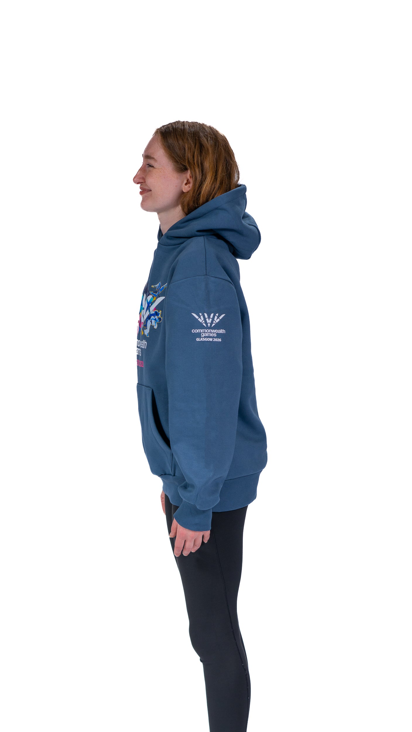 Side view of woman wearing denim Glasgow 2026 Celebration graphic hoodie.