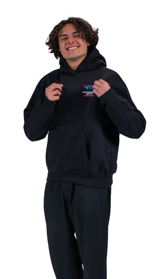 Front view of man wearing black hoodie with Glasgow 2026 logo.
