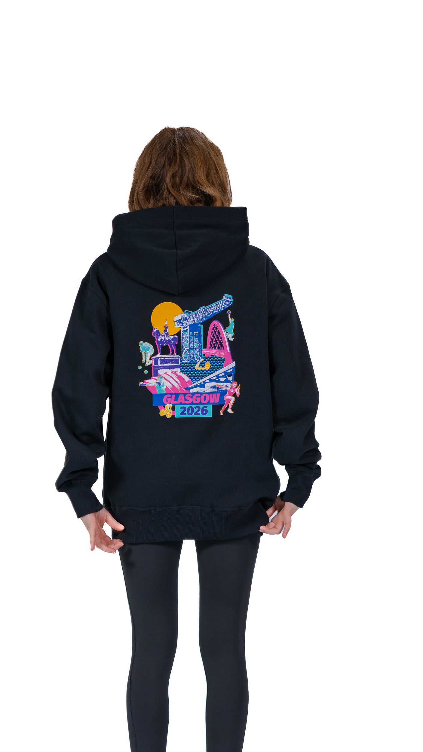 Back view of woman wearing black hoodie with Glasgow 2026 Cityscape graphic.