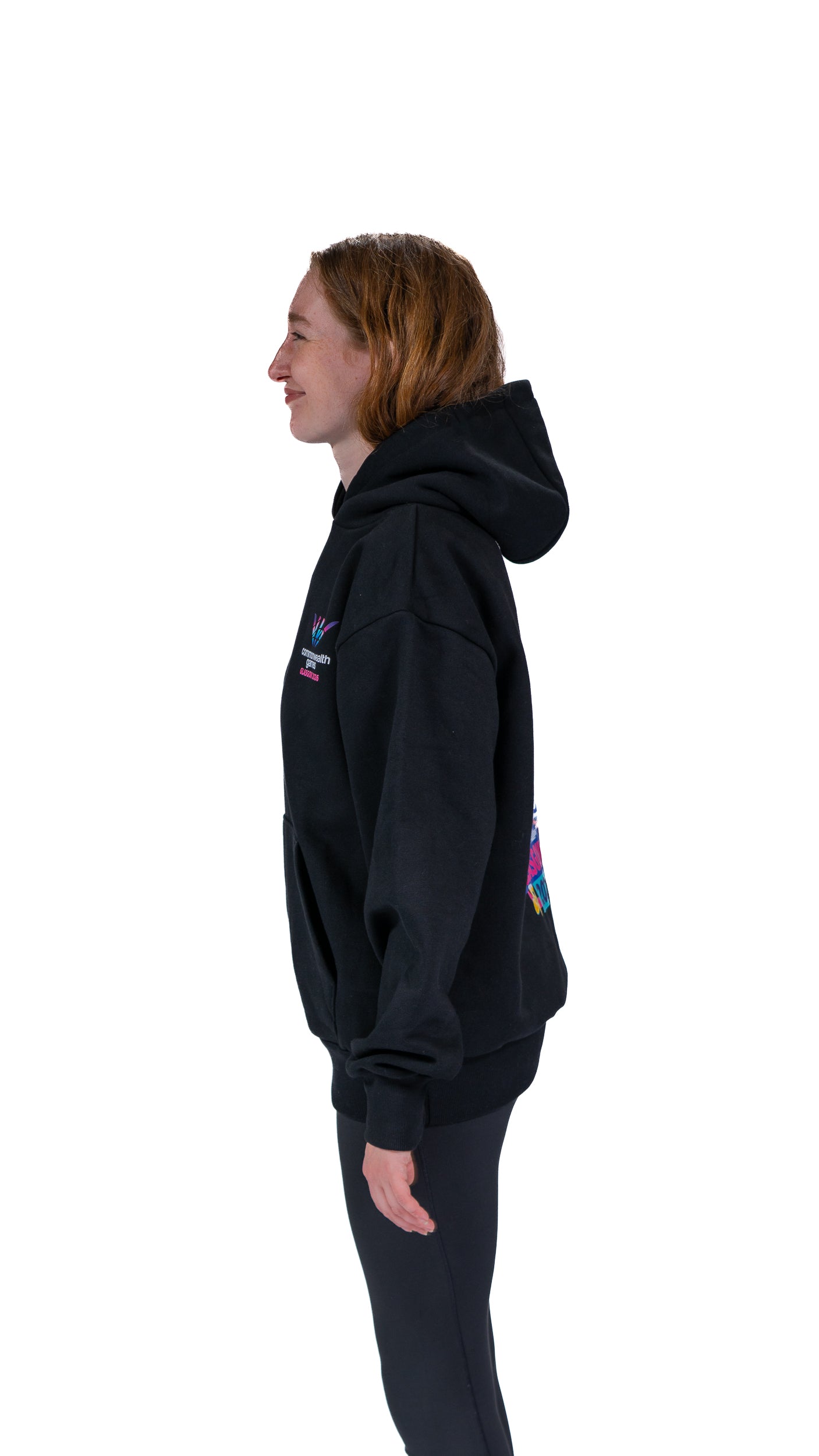 Side view of woman wearing black Glasgow 2026 Cityscape hoodie. 