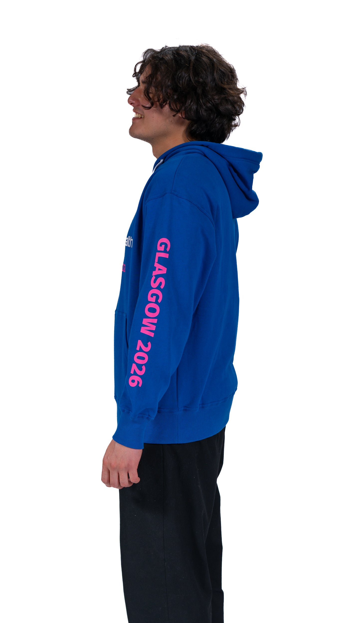 Side view of man wearing unisex, denim hoodie showing Glasgow 2026 on the sleeve.