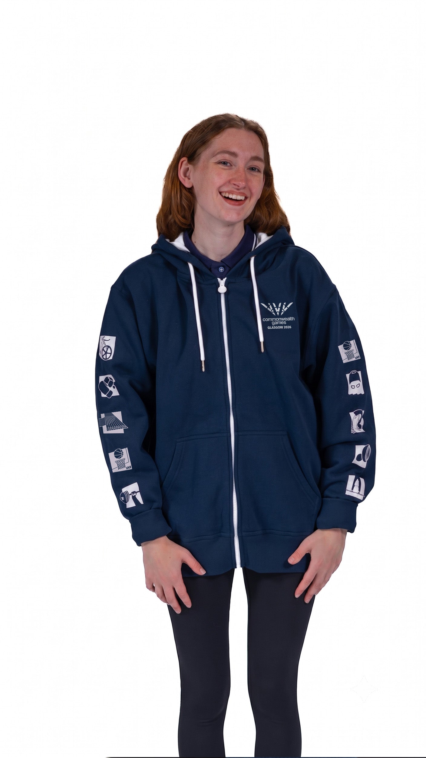 Front view of woman wearing contrast navy/pink hoodie with mono Glasgow 2026 logo on the left chest and sports pictograms on the arms.