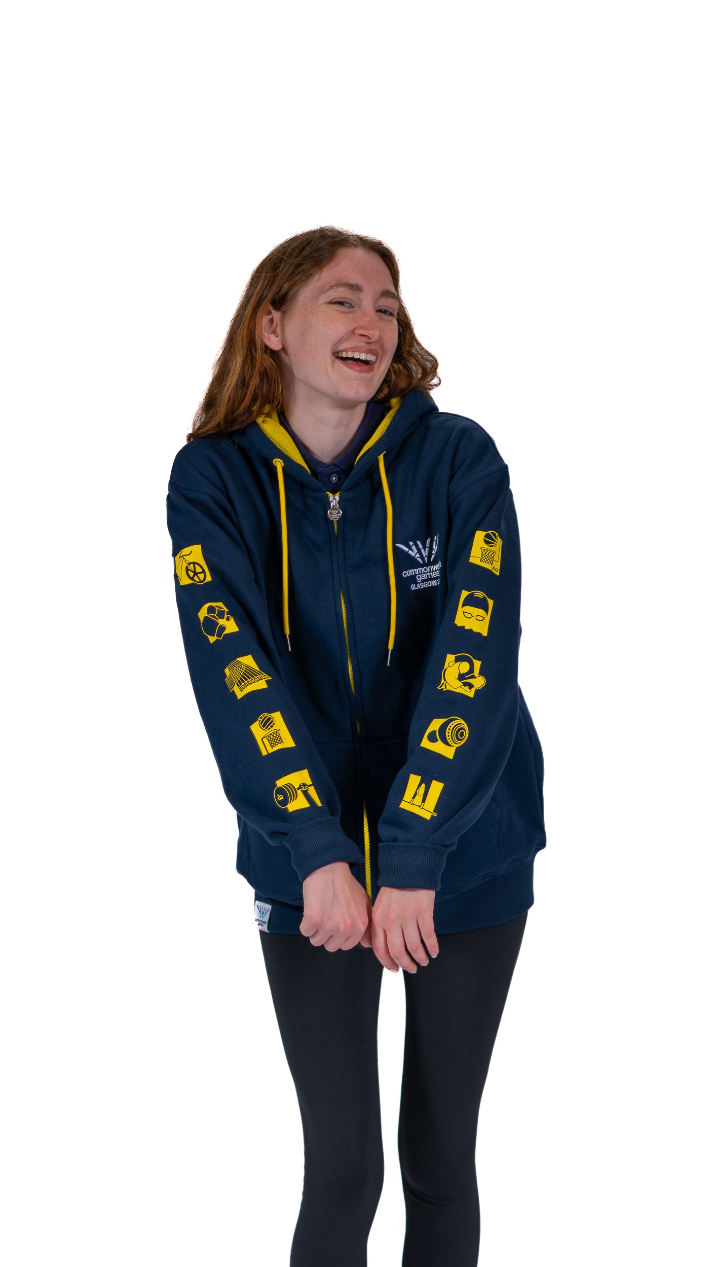 Front view of woman wearing contrast navy/yell hoodie with mono Glasgow 2026 logo on the left chest and sports pictograms on the arms.