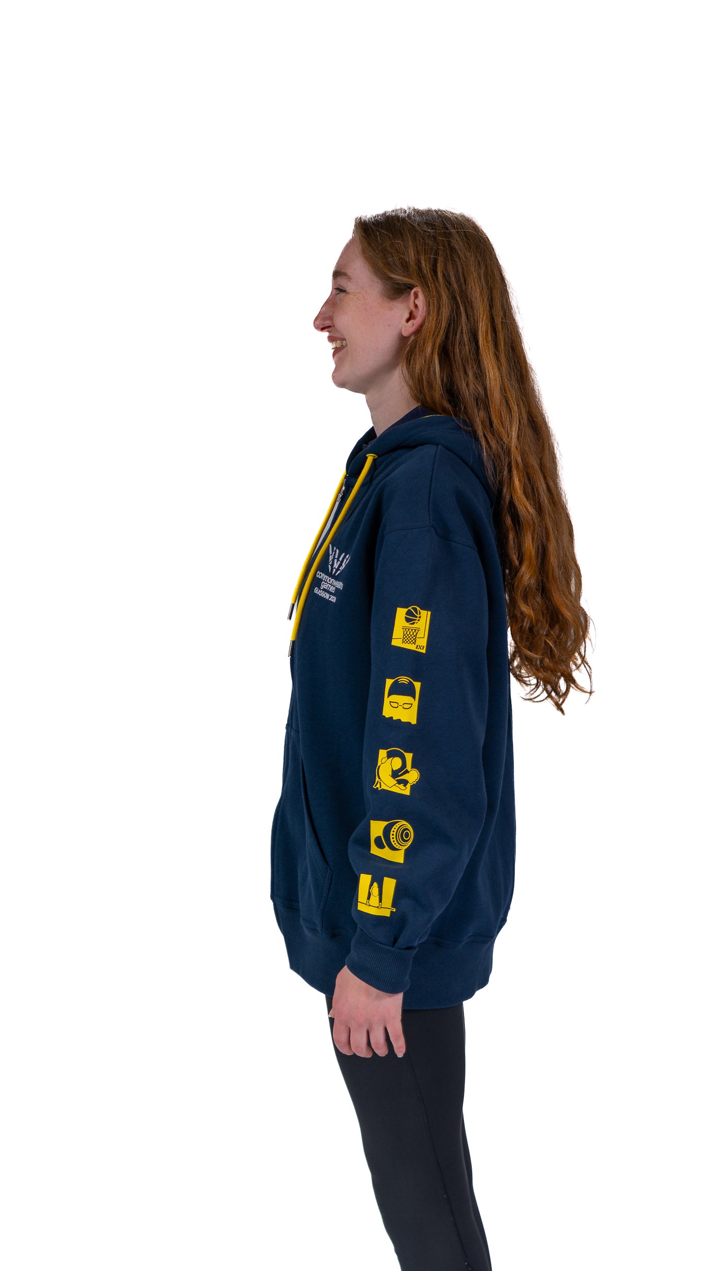 Front view of woman wearing contrast navy/yellow hoodie with mono Glasgow 2026 logo on the left chest and sports pictograms on the arms.