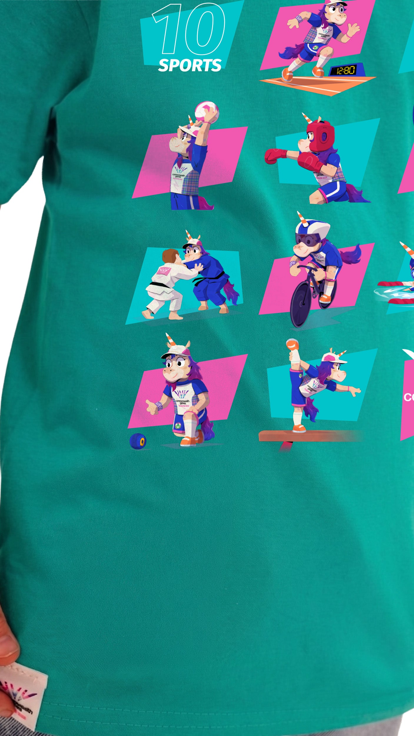 Close up view of young boy wearing green Glasgow 2026 Finnie Mascot sport pictograms t-shirt.