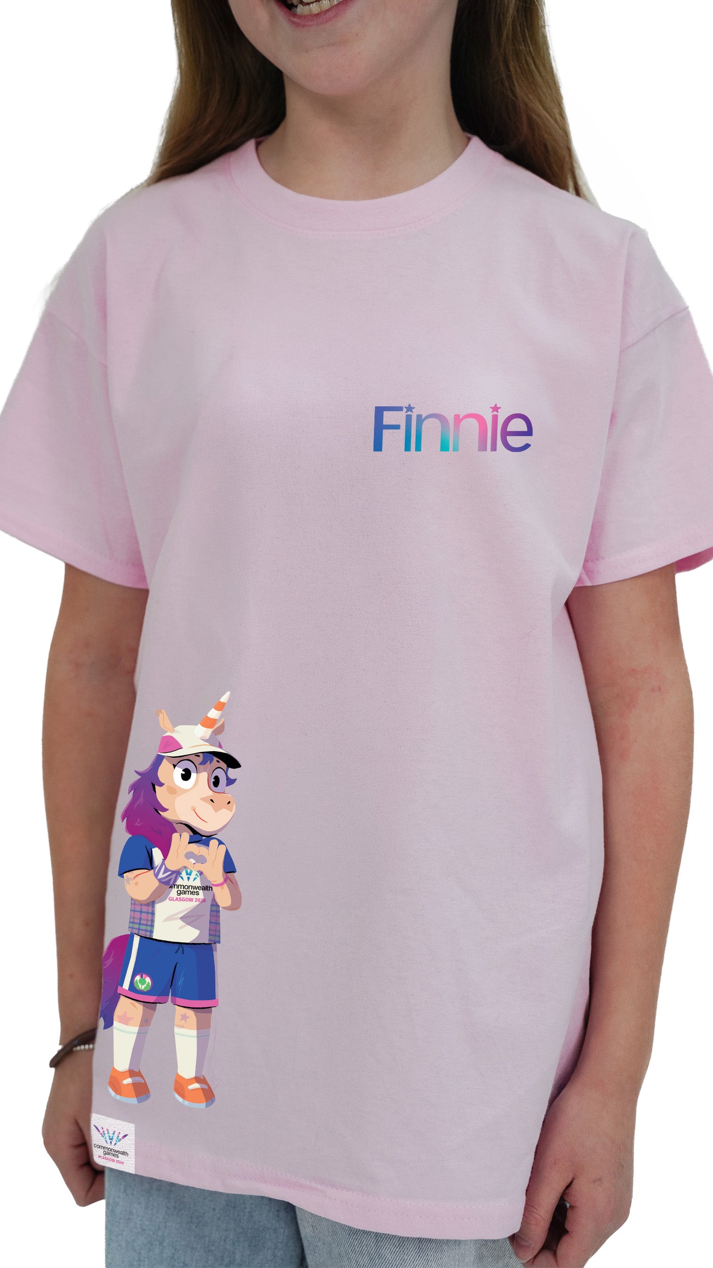 Close up of young girl wearing light pink Glasgow 2026 Finnie Mascot side print t-shirt.