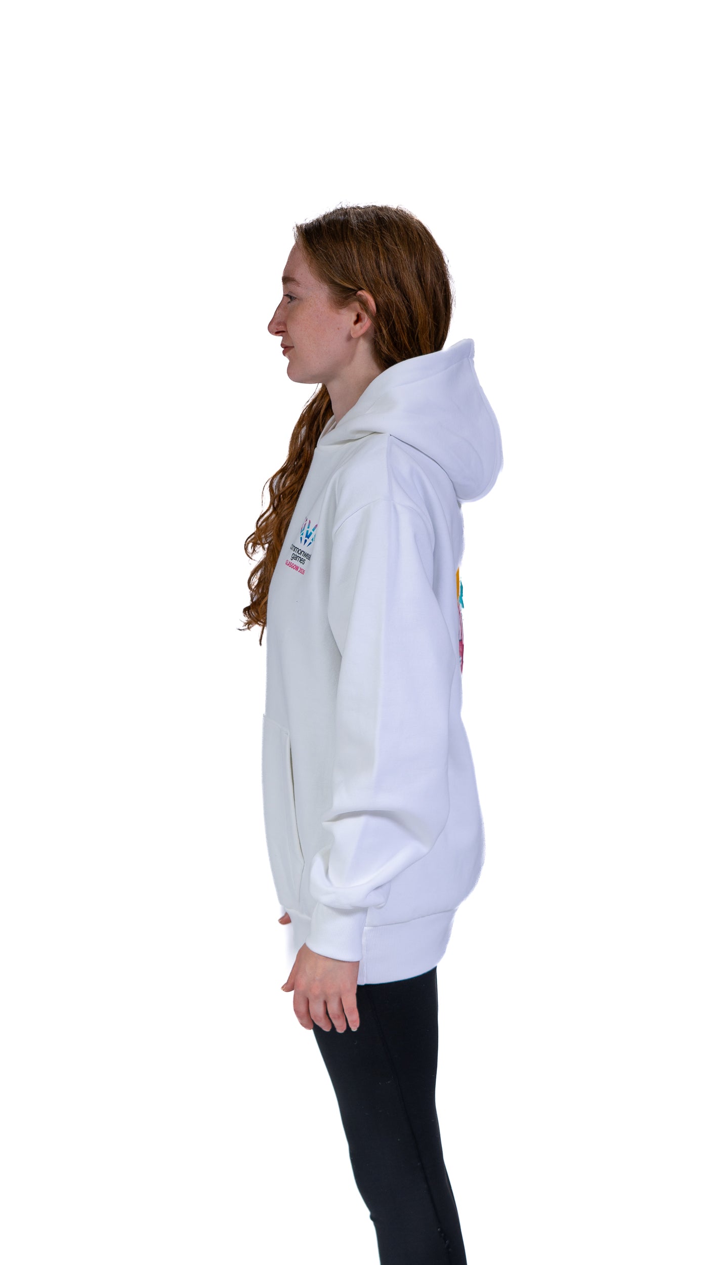 Side view of woman wearing white Glasgow 2026 Cityscape hoodie. 