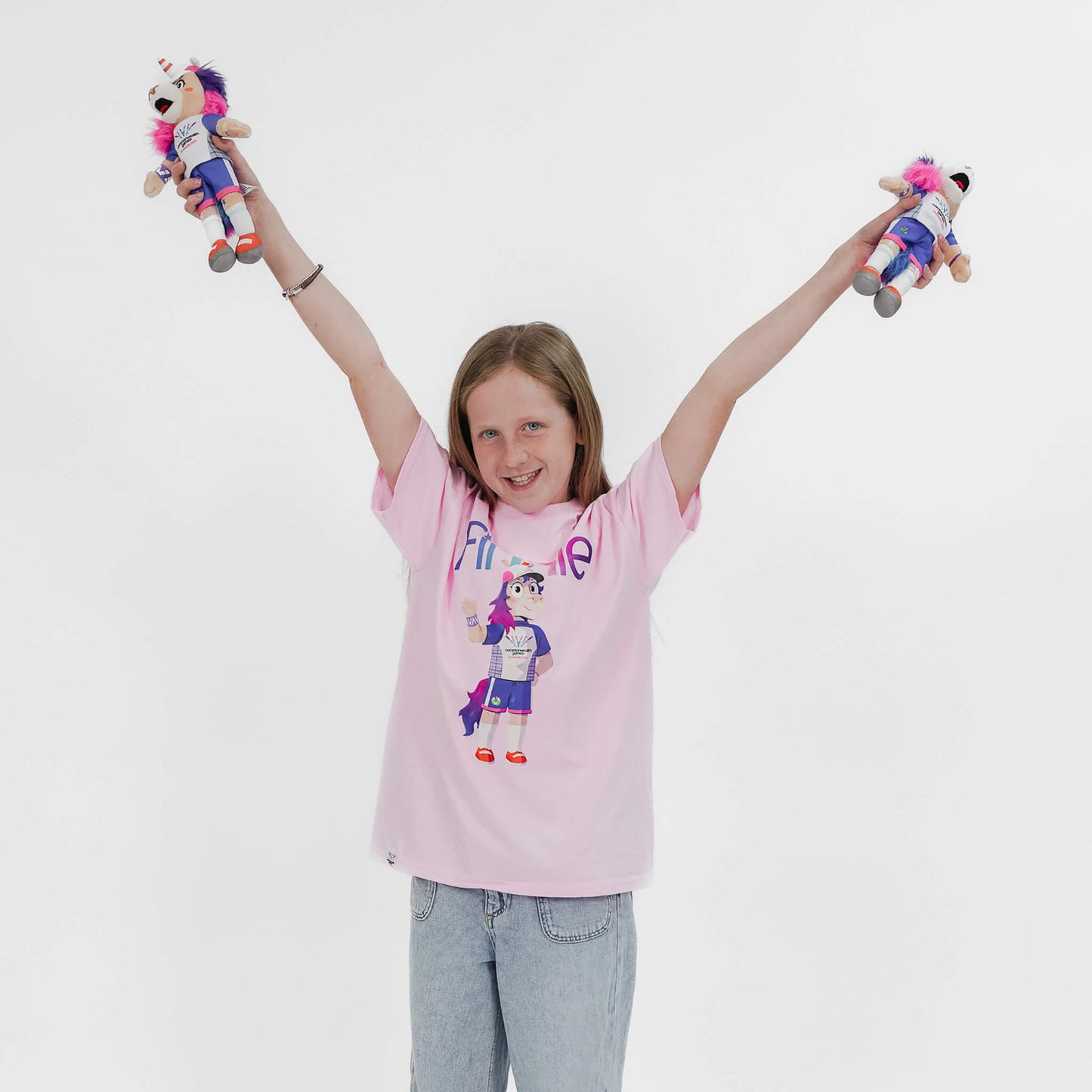 Girl holding 2 Glasgow 2026 Finnie Mascots - 25cm
