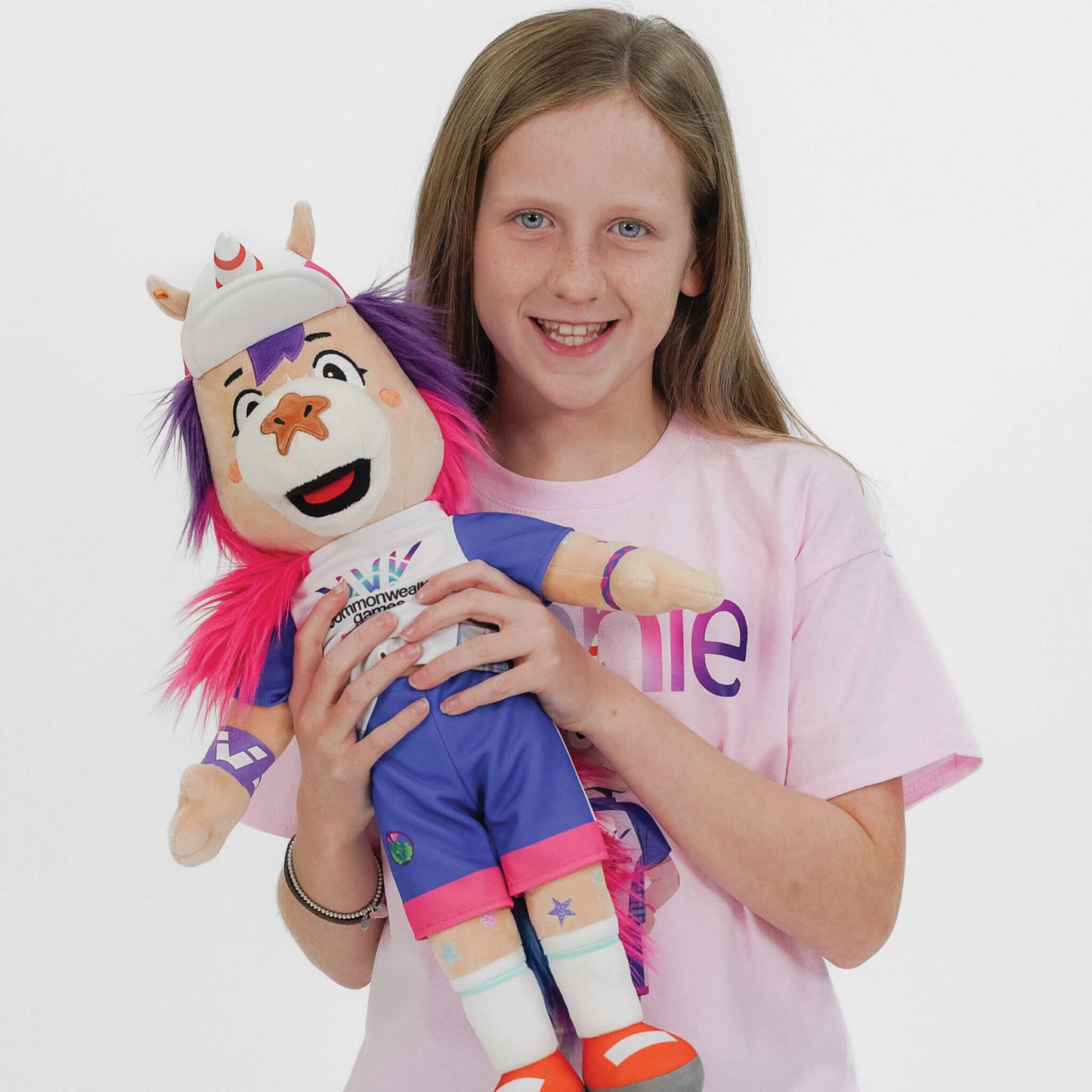 Young girl holding a 50cm Finnie Glasgow 2026 Mascot Plush