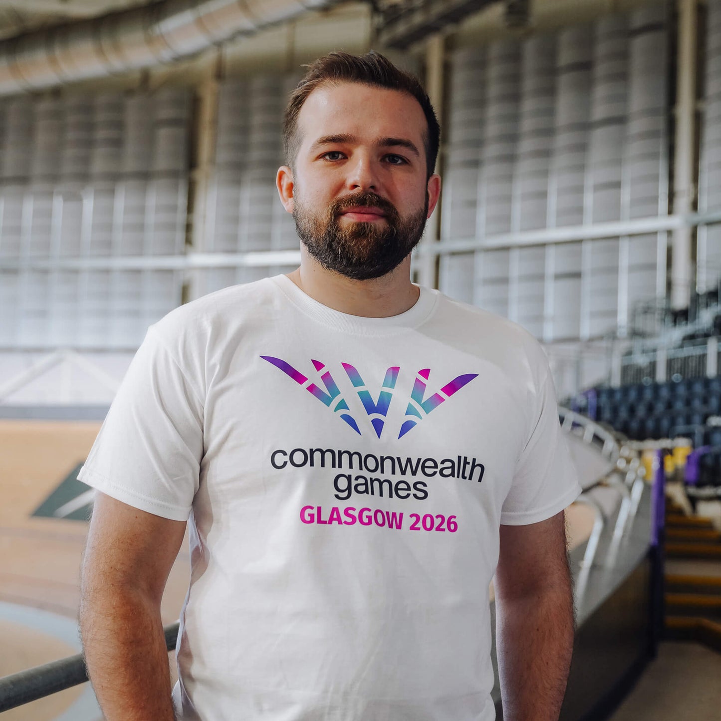 Man wearing white Glasgow 2026 logo t-shirt