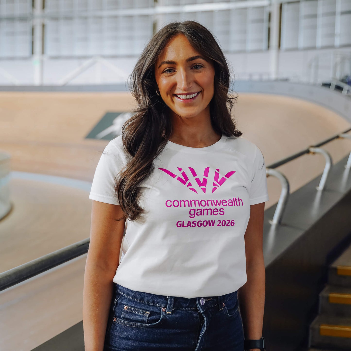 Woman wearing white single colour Glasgow 2026 logo fitted t-shirt