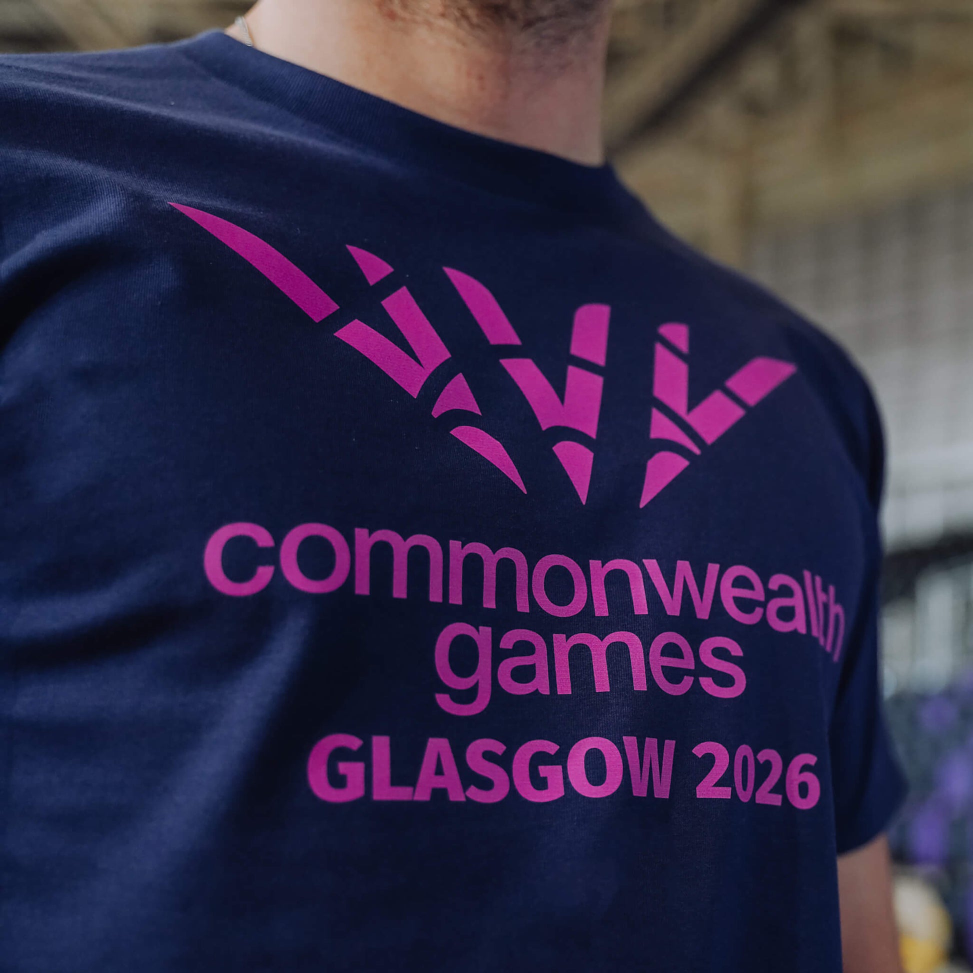 Close up of navy single colour Glasgow 2036 logo t-shirt showing chest print