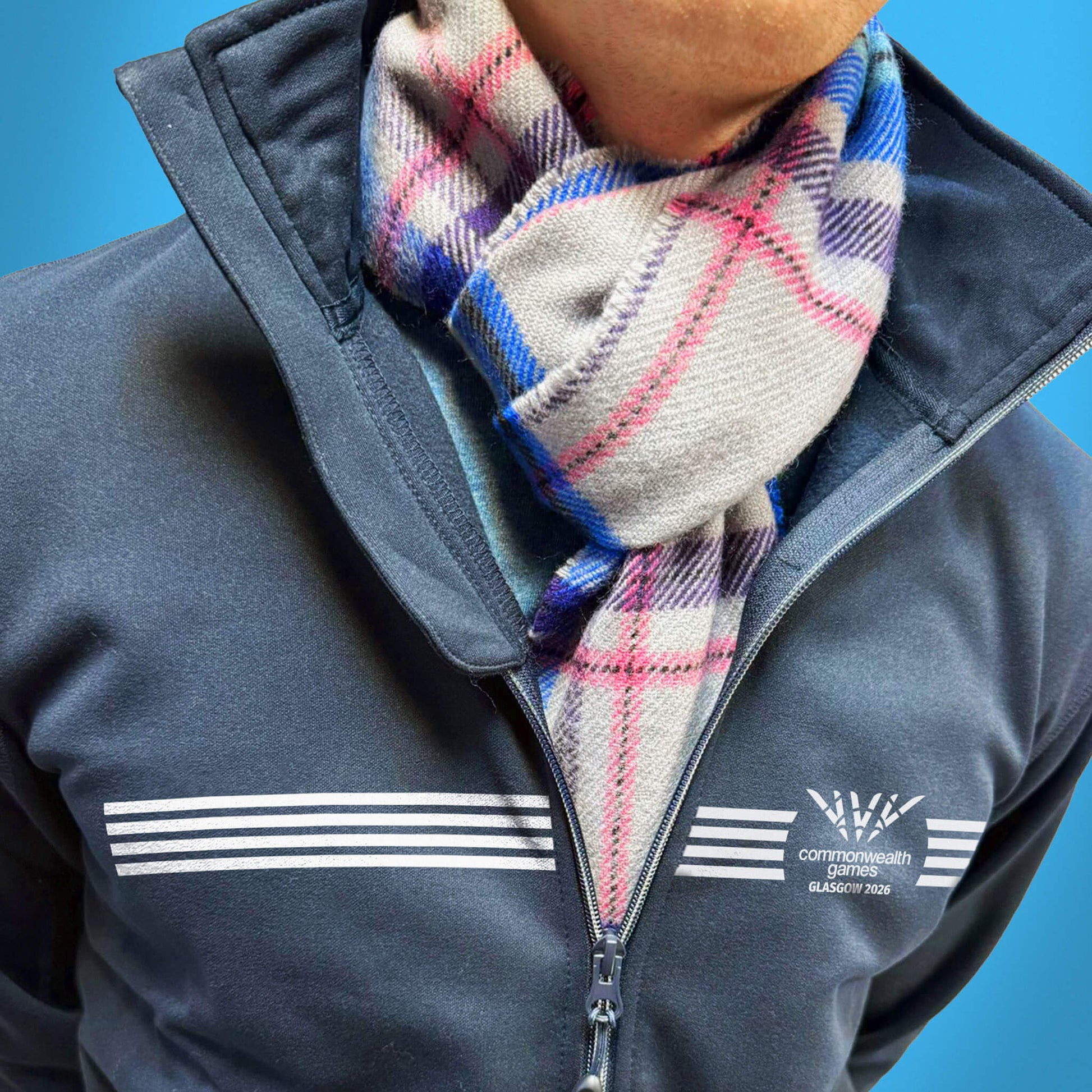 Man wearing Official Glasgow 2026 tartan lambswool scarf