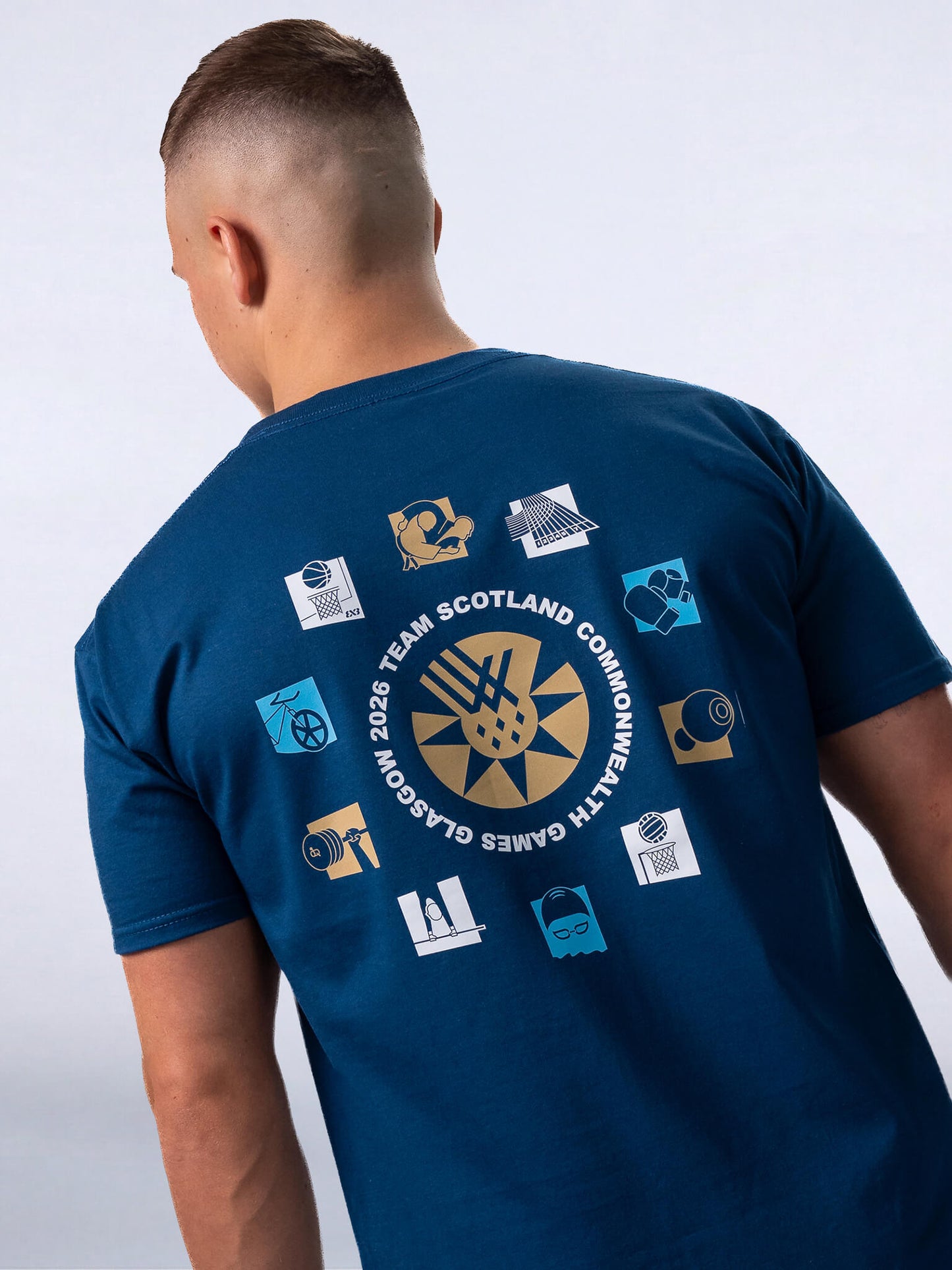 Back View of Mountain Blue G2026 x Team Scotland Gold Sport Icons T-Shirt worn by athlete Pavel Karnejenko